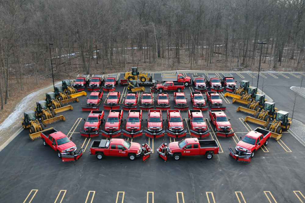 Photo of all of Timberland Landscaping's trucks and equipment